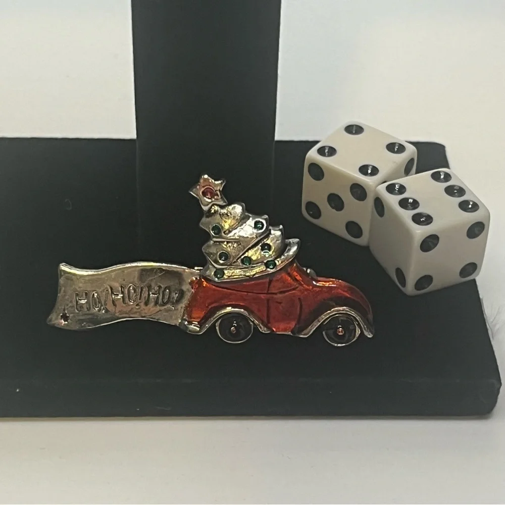 Vintage Christmas brooch, metal and enamel. There’s a dark spot on the Ho Ho Ho